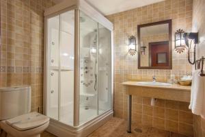 a bathroom with a shower and a toilet and a sink at Hotel Moya in Honrubia