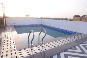 a swimming pool on the roof of a building at Hotel Grand Empire, Banquet, Swimming Pool with Taj View in Agra