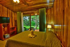 a bedroom with a bed and a large window at Mar Inn Costa Rica in Monteverde Costa Rica