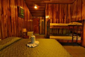 a bedroom with two bunk beds in a wooden room at Mar Inn Costa Rica in Monteverde Costa Rica