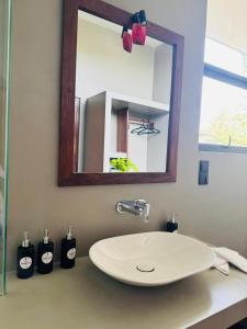 a bathroom with a white sink and a mirror at Luma Malee Resort in Dickwella +36 photos