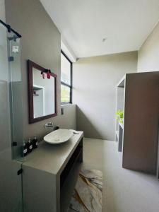 a bathroom with a sink and a mirror at Luma Malee Resort in Dickwella