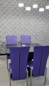 two laptops sitting on a table with purple chairs at Sunshine Residence Silver Apartment in Hévíz