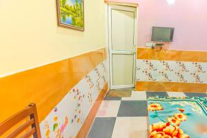 a room with a staircase with a door and a tiled floor at Shree Ladli Ju Dham in Vrindāvan