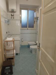 a bathroom with a toilet and a sink at B&B Donna Elvira in Siderno Marina +9 photos