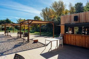 a pavilion with tables and chairs on a patio at Camping El Pasqualet in Caldes de Montbui