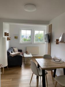 a living room with a couch and a table at Haffquartier - "Zur Alten Bäckerei" in Mönkebude