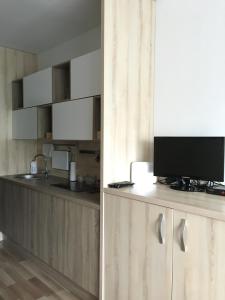 una cocina con TV en la parte superior de un mostrador en Mikes Apartman, en Szekszárd