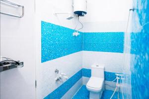 a blue and white bathroom with a toilet in it at Shree Ladli Ju Dham in Vrindāvan