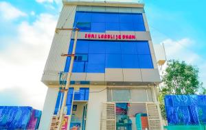 a building with a sign on the side of it at Shree Ladli Ju Dham in Vrindāvan
