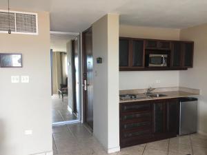 a kitchen with wooden cabinets and a counter top at Villa 2302 Costa Bonita Beach Resort in Culebra