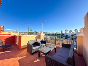 a patio with chairs and tables on a balcony at Altos Bahia Magic in Torrevieja