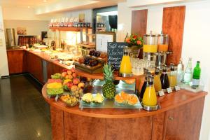 a counter with a bunch of fruit and juice at Hotel National Düsseldorf (Superior) in Düsseldorf