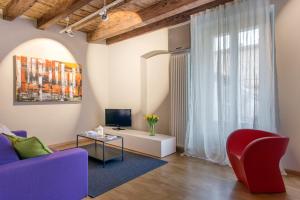 a living room with a couch and a tv at La Cortevecchia 2.0 in Bergamo