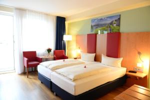 Ένα ή περισσότερα κρεβάτια σε δωμάτιο στο Hotel National Düsseldorf (Superior)