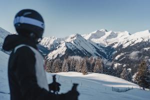 a person standing on top of a snow covered mountain at JONI Apartments Berwang in Berwang