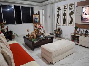 a living room with a couch and a table at Hospedagem Porto Barra in Salvador