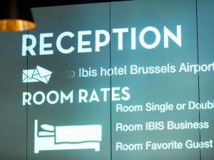 a sign for a hotel with a sign for room rates at ibis Hotel Brussels Airport in Diegem