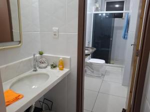 a white bathroom with a sink and a toilet at Hospedagem Porto Barra in Salvador +68 photos