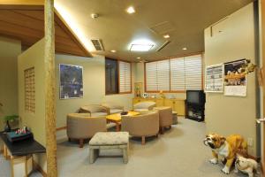 a waiting room with a dog sitting in the middle at Nakayasu Ryokan in Kanazawa