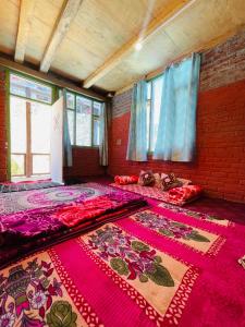 an empty room with carpets on the floor and windows at Mj home in Kalgha +92 photos