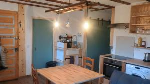 a kitchen with a wooden table in a room at La Châtelaine in La Rixouse