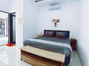 a bedroom with a bed in a white room at Joy Private Pool Villa in Kuta