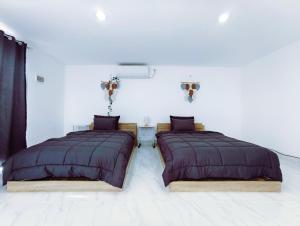 two beds sitting next to each other in a room at Joy Private Pool Villa in Kuta +82 photos