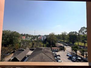a view of a parking lot with cars parked at Comfort Big condo in Chiang Mai