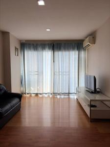a living room with a couch and a television at Comfort Big condo in Chiang Mai