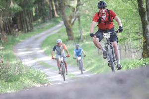 a group of people riding bikes down a road at B&B Les Soigneurs in Grandmenil