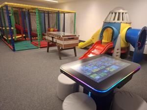 a childrens play room with a table with a tablet at B&B Kaiserstube in Flachau