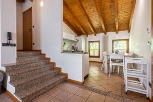 a staircase in a house with a kitchen and a table at Appartamento Al Forte e Appartamento Orizzonte59 in Nago-Torbole