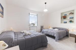 a bedroom with two beds and a window at Scala Center big holiday house in Scala
