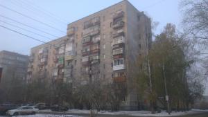 a tall building with cars parked in front of it at "GOOD NIGHT" on Pirogova 7 in Tomsk