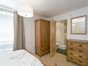 a bedroom with a bed and a bathroom with a mirror at Jorvik- Woodsmill Quay in York +5 photos