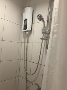 a shower in a bathroom with a soap dispenser at XX GO INN Khaosan Bangkok - ถนนข้าวสาร กรุงเทพมหานคร in Bang Bua Thong Railway Station +16 photos