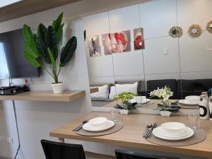 a dining room with a table with plates on it at Apartment 2 Quezon City Condo Pool View in Manila