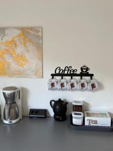 a kitchen counter with a coffeemaker and a coffee station at Home Ida in Klotten
