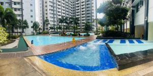 a large pool with blue water in a building at New 1BR in Mandaluyong 40SQM in Manila