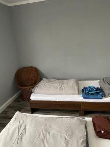 two twin beds in a bedroom with a chair at Mila's Fewo in Stollberg