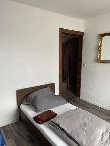 a bedroom with a bed and a mirror on the wall at Mila's Fewo in Stollberg