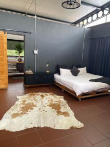 a bedroom with a bed and a rug on the floor at Hartbeespoort Escape Hot Tub and Mountain Views in Skeerpoort +90 photos