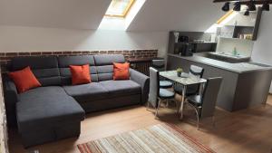 a living room with a couch and a table at My Central Home in Miercurea-Ciuc