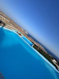 an aerial view of a pool with blue water at Amallini Suites Mykonos in Super Paradise Beach