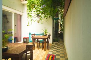 a dining room with tables and chairs and plants at Suriya Homestay Mirissa in Mirissa