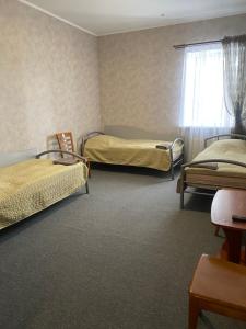 a room with two beds and a window at Avtoport Restorant Hotel Complex in Vinnytsya