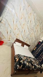 a bed in a room with a wall mural at Hotel Indian Lemon Tree in Jīnd
