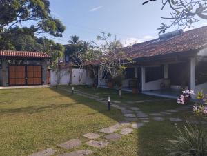a backyard of a house with a yard with a yard at Lausanne villa in Dharga Town