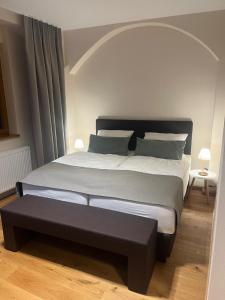 a bedroom with a large bed with a black headboard at Die Meissen Lodge in Meißen +27 photos